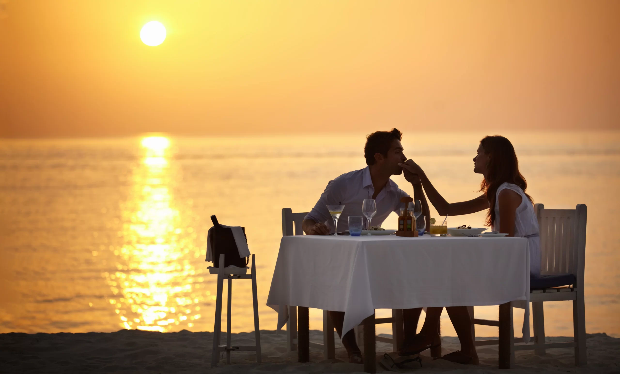 Man on the beach with the love of his life - FG Luxury Travel
